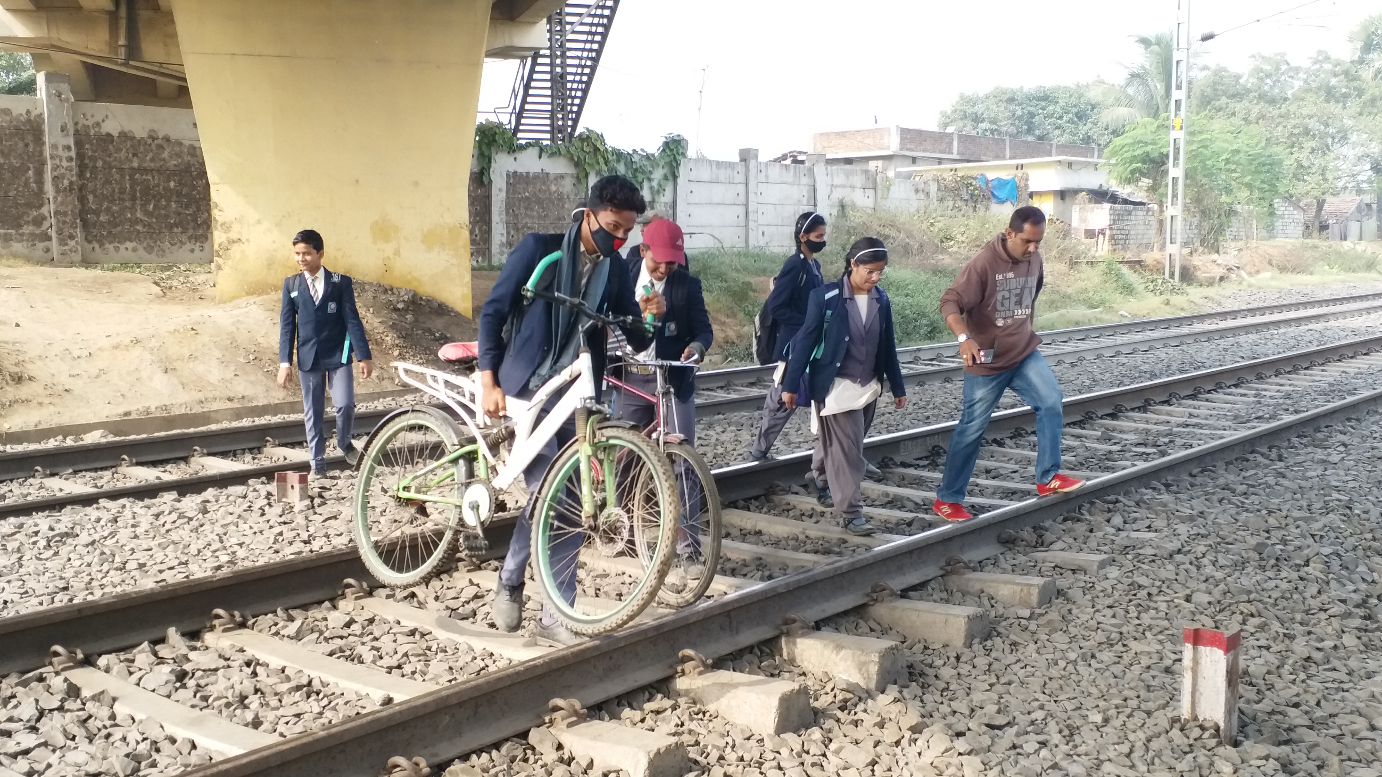 Children go to school by crossing railway track