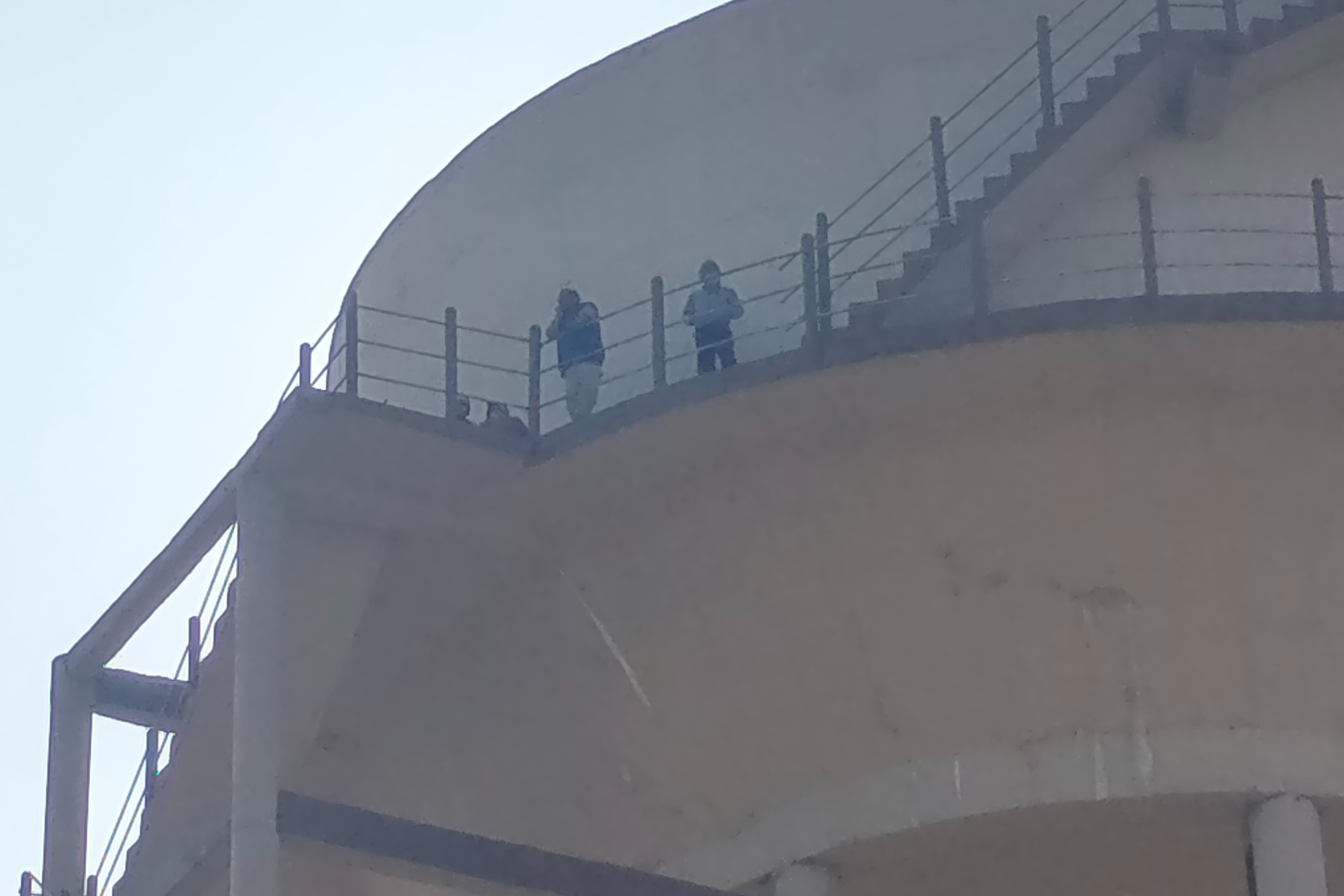 Farmer climbed with family on water tank