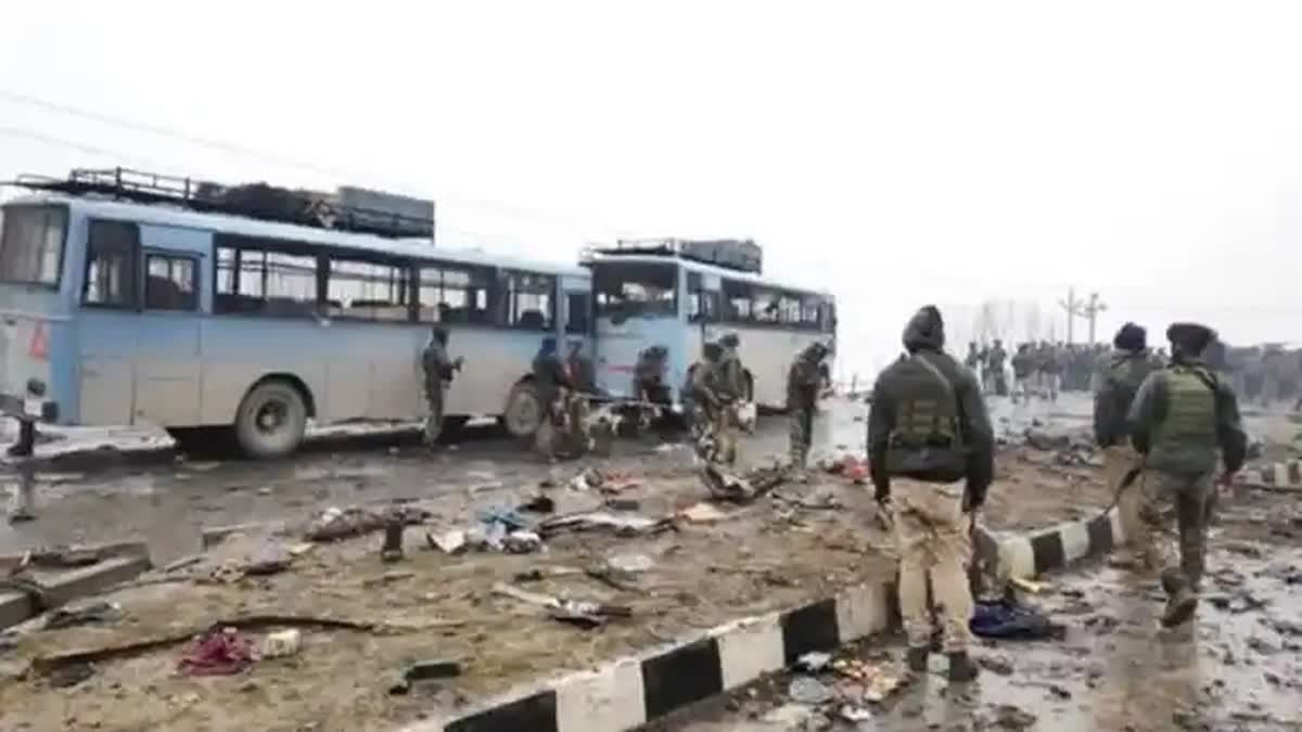 Security forces examine the spot where 40 CRPF personnel were killed in a suicide attack at Lethpora area of Pulwama district in Jammu and Kashmir