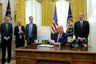 President Donald Trump speaks to reporters before signing an executive order as White House national economic council director Kevin Hassett, from left, White House senior counselor for trade and manufacturing Peter Navarro, White House staff secretary Will Scharf and Commerce Secretary nominee Howard Lutnick watch, in the Oval Office of the White House, Thursday, Feb. 13, 2025, in Washington.