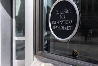 A bouquet of white flowers placed outside the headquarters of the United States Agency for International Development, or USAID, is pictured, Friday, Feb. 7, 2025, in Washington.