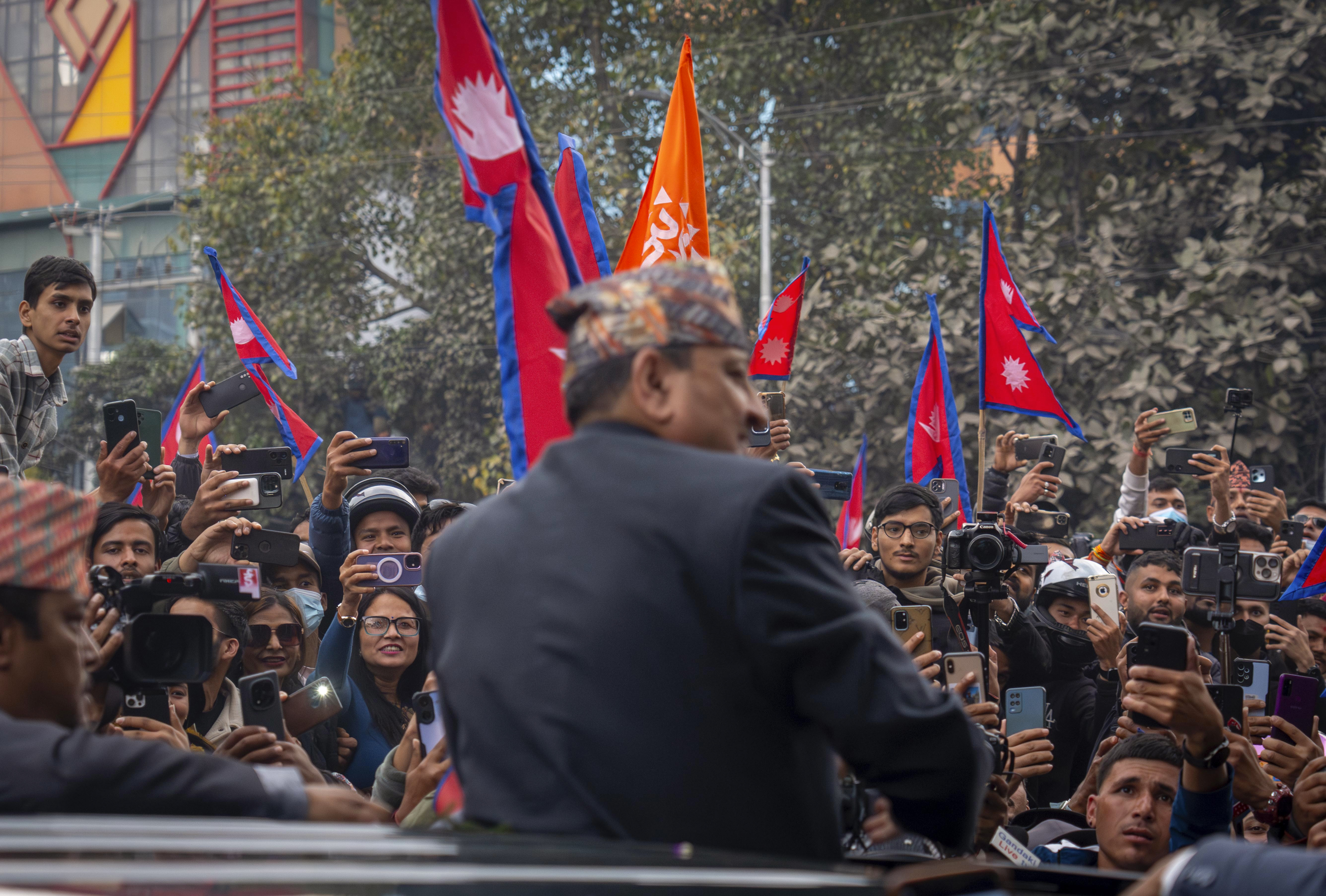 Supporters gather to welcome Nepal's former King Gyanendra Shah upon his arrival at Tribhuvan International Airport in Kathmandu