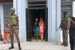 Security forces stand guard at a polling station during voting in the fourth phase of Lok Sabha election 2024 in Srinagar
