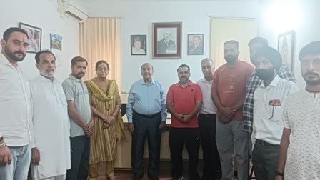 Rattan Lal Gupta Provincial President Jammu Province (C) poses with party workers in Jammu on Friday June 14, 2024