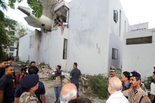 The tail part of the aircraft stuck in the BJ Medical College Hostel.