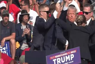 This video screenshot shows former U.S. President Donald Trump being helped off the stage at a rally in Butler, Pennsylvania of the United States after what sounded like gunshots rang out through the crowd, July 13, 2024.