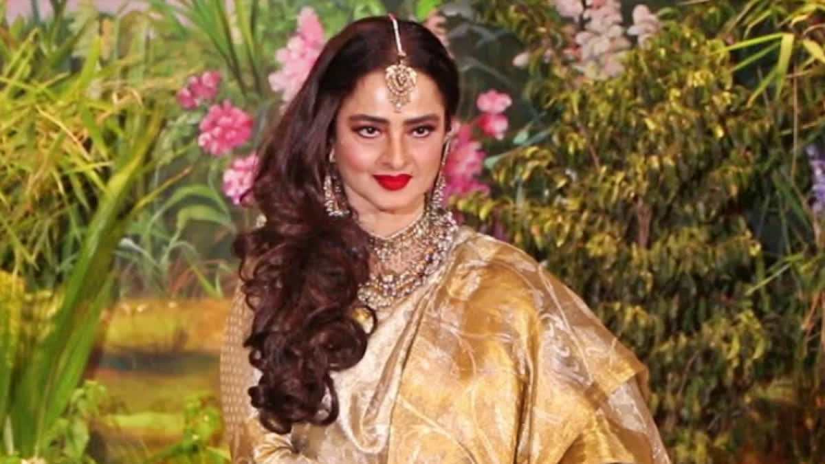 Bollywood actor Rekha never fails to impress the audience with her fashionable yet timeless attire. On Wednesday, the iconic actor was spotted attending an award show in Mumbai, and she looked captivating enough in her stunning beige and golden suit-saree ensemble. Now, a video from the event that has gone viral on the internet in no time shows the veteran actor slapping a man in jest after posing with him.