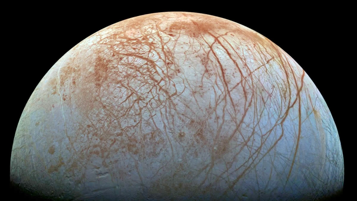 The puzzling surface of Jupiter’s icy moon Europa looms large in this reprocessed color view made from images taken by NASA’s Galileo spacecraft in the late 1990s. The images were assembled into a realistic color view of the surface that approximates how Europa would appear to the human eye.