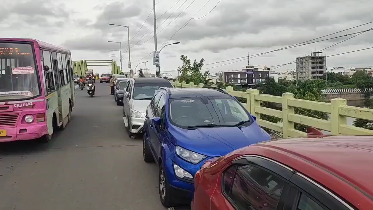 Vehicles parked in a row on the flyover in Velachery