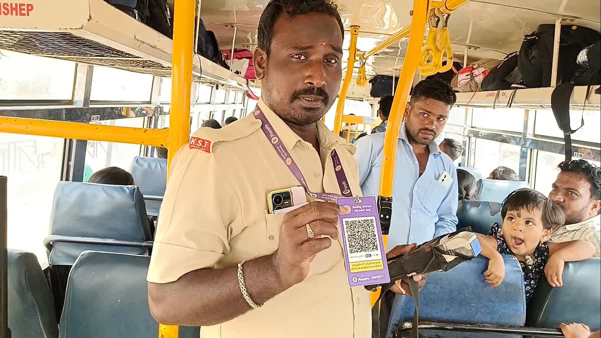 NWKRTC Bus conductor holding QR Code