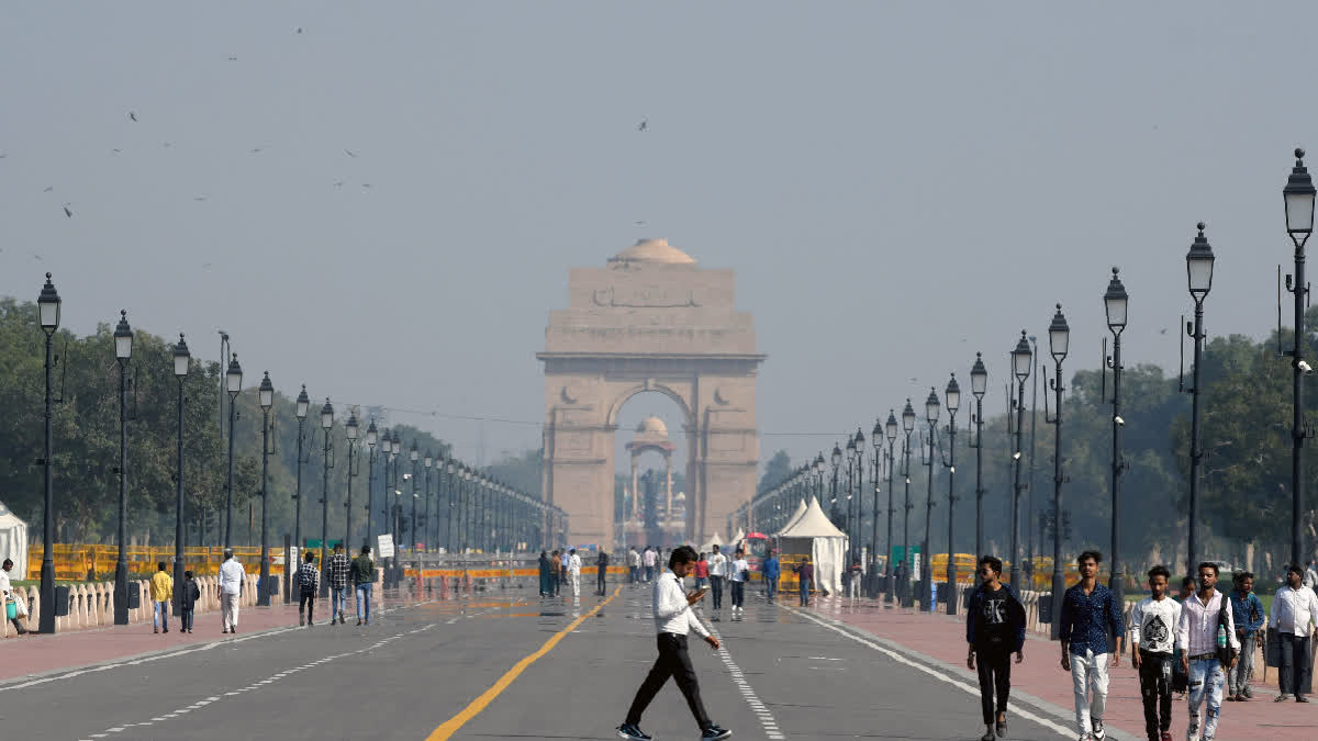 People take a stroll at the Kartavya Path as the air quality slightly improves in New Delhi.