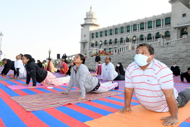 surya namaskar in front of Suvarna Soudha