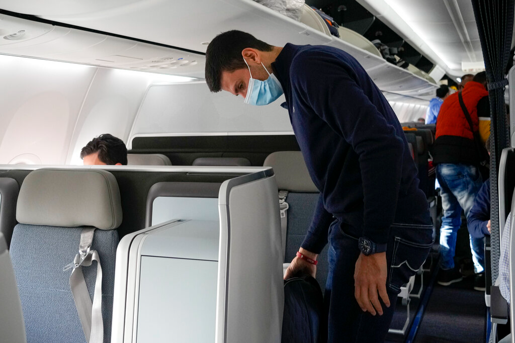 Novak Djokovic prepares to take his seat on a plane to Belgrade, in Dubai, United Arab Emirates