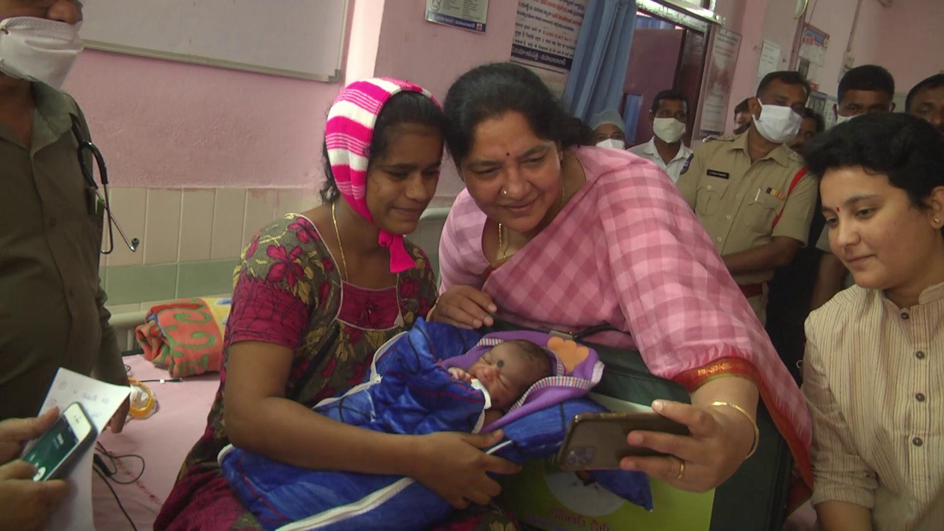 Minister taking selfie with mother and child