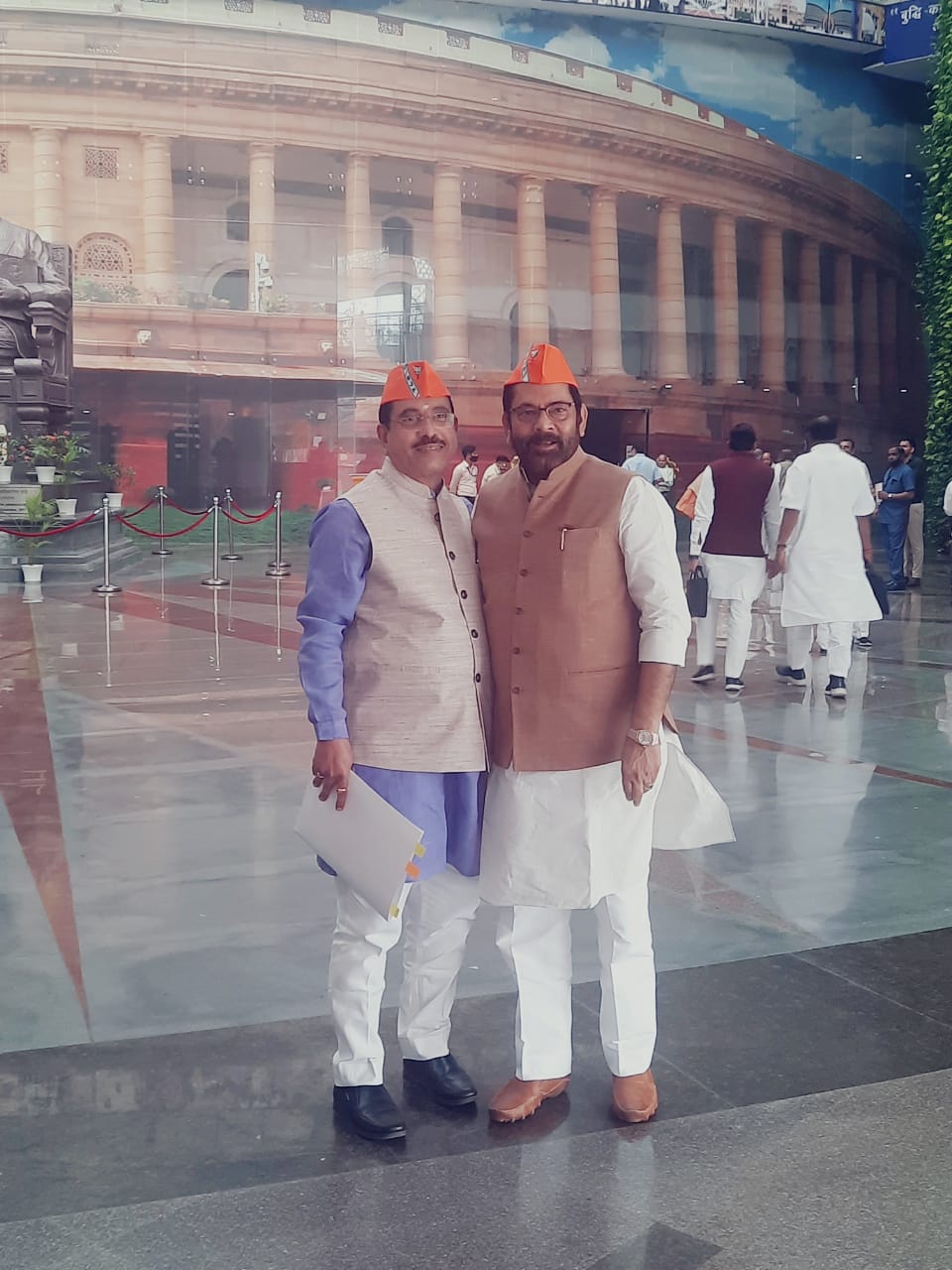 BJP MPs Mukhtar Abbas Naqvi and Prahlad Joshi sporting the new party caps