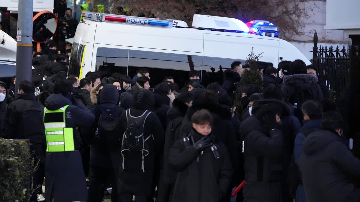 Police officers gather outside of the gate of the presidential residence in Seoul, South Korea, Wednesday, Jan. 15, 2025.