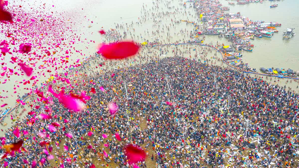 Flower petals being showered on devotees during the Maha Kumbh 2025