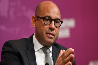 UN climate chief Simon Stiell delivers a speech on stage at Chatham House, in London, on April 10, 2024.