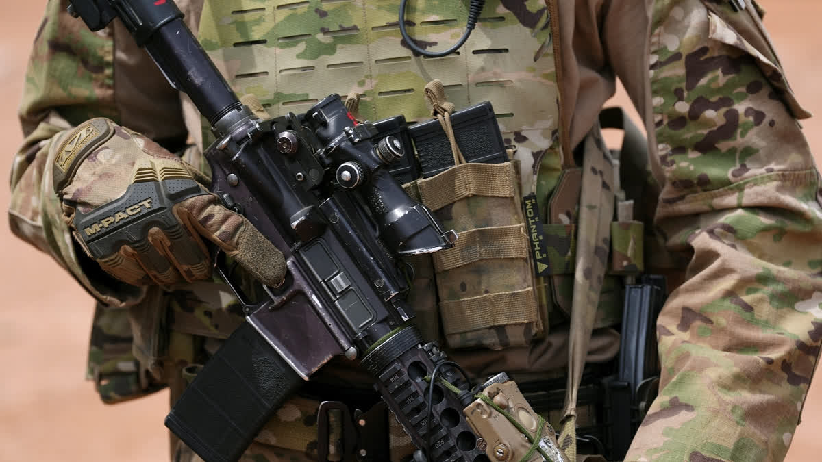 A member of the U.S. Army 212 Infantry 2nd Brigade stands next to the US-Mexico border as part of Joint Task Force Southern Border Thursday, April 3, 2025, in Douglas, Ariz.