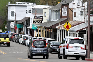 Cars drive on the main street in Julian, Calif. Monday, April 14, 2025, after an earthquake shook Southern California, sending boulders tumbling onto rural roadways outside San Diego and rattling items off shelves and walls.
