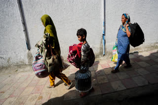 Villagers living along the Line of Control between India and Pakistan return to their village from temporary shelters, in Akhnoor Sector, India.
