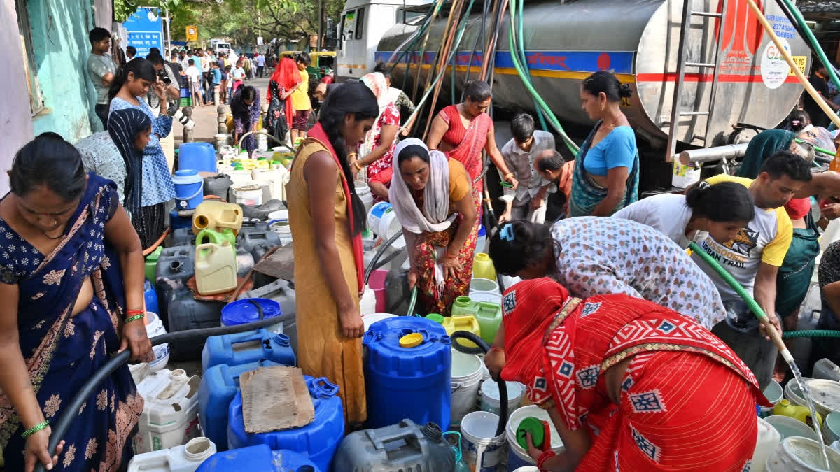 People fill their buckets from a water tanker as water crisis continues, at Vivekananda Camp in New Delhi on Thursday.