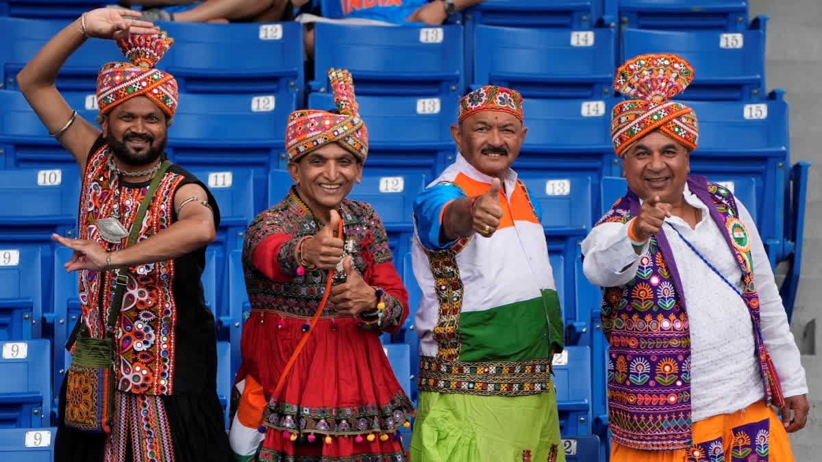 Indian fans in traditional attire react to the camera as they wait for the start of the ICC Men's T20 World Cup cricket match between Canada and India at the Central Broward Regional Park Stadium, Lauderhill, Fla., Saturday, June 15, 2024.