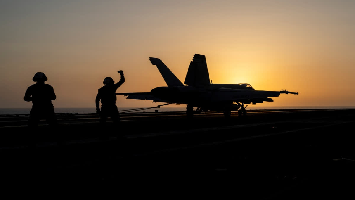 A fighter jet lands on the USS Dwight D. Eisenhower, also known as "IKE," in the Red Sea on Tuesday, June 11, 2024.