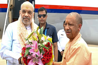 In this image released by @myogiadityanath via X on June 15, 2025, Union Home Minister Amit Shah being received by Uttar Pradesh Chief Minister Yogi Adityanath upon his arrival in Lucknow.