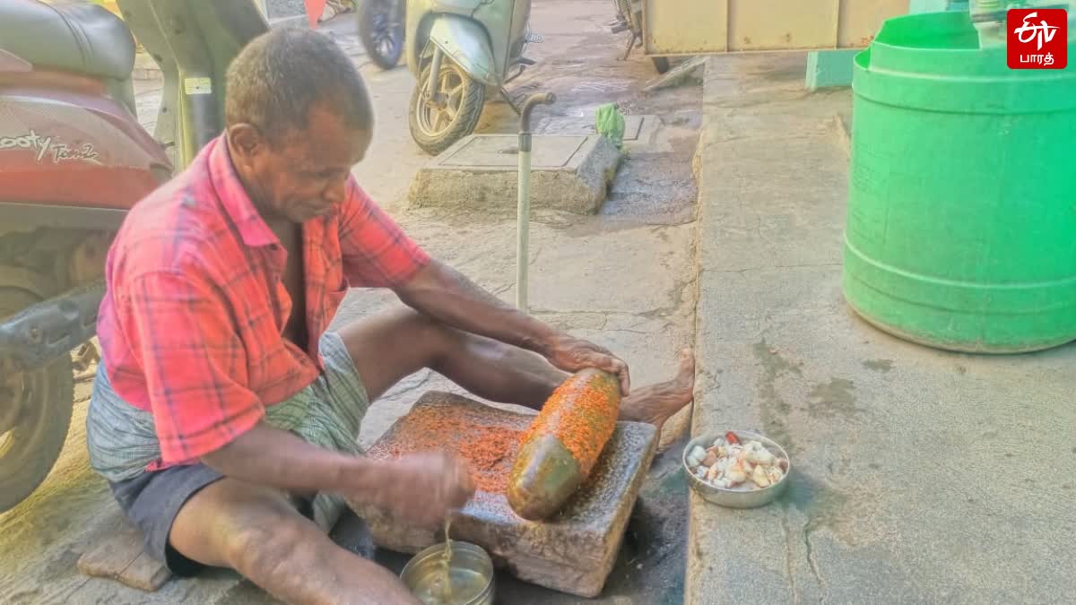 old man grinding masala in ammikal