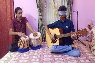 teenager-playing-guitar-blindfolded-in-west-bengal-enters-asia-book-of-records