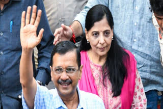 Delhi Chief Minister Arvind Kejriwal waves to people as he visits Hanuman Temple with his wife Sunita Kejriwal to offer prayers after being released from Tihar Jail following the Supreme Court bail granted to him in the Delhi excise policy case, at Connaught Place, in New Delhi on Saturday