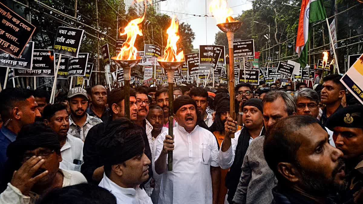 Leader of the Opposition Suvendu Adhikari  with others take part in a torch rally in Kolkata on Tuesday.