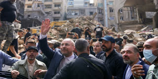 Iran's parliament speaker Mohammad Bagher Qalibaf, second left, waves to residents as visit the site of Thursday's Israeli airstrike in Beirut, Lebanon, Saturday, Oct. 12, 2024.