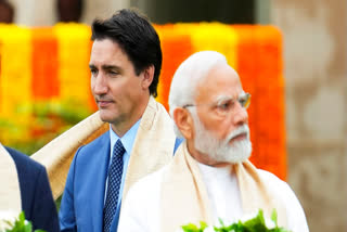 Canada's Prime Minister Justin Trudeau, left, walks past Prime Minister Narendra Modi as they participate in a wreath-laying ceremony at Raj Ghat during the G20 Summit in New Delhi, Sept. 10, 2023.