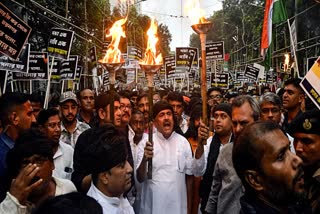 Leader of the Opposition Suvendu Adhikari  with others take part in a torch rally in Kolkata on Tuesday.