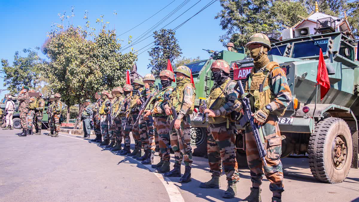 Army personnel stand guard as protest erupts across Manipur demanding the repeal of Armed Forces (Special Powers) Act, in Imphal