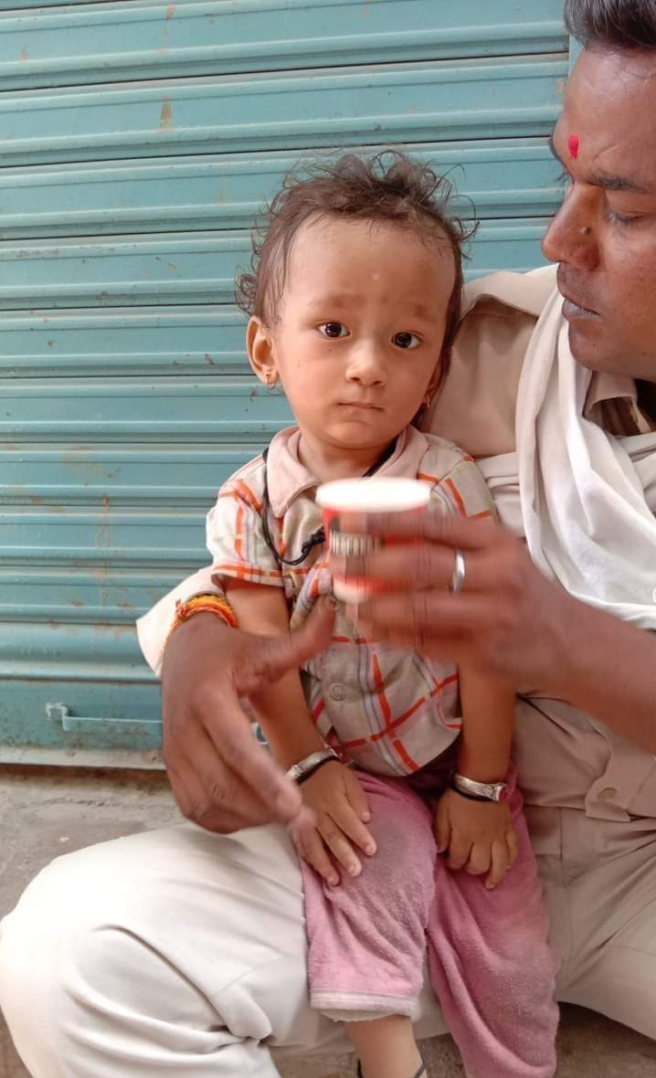 Innocent crying by hanging on mother's feet