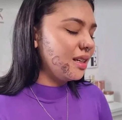 tattooing his name on girlfriend face