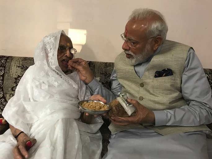 Prime Minister Modi is giving sweet to his mother