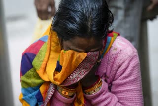 A relative of Poonam Devi, who died in the stampede, mourns outside the mortuary at the LNJP Hospital in New Delhi on Sunday.