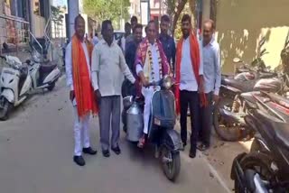 MALLA REDDY DRIVING A MILK BIKE