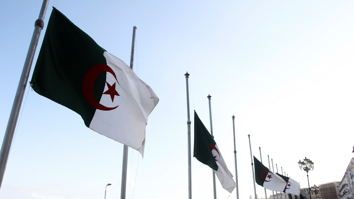 FILE - Algerian flags fly at half-staff along the seaside walk in Algiers, Saturday, Sept. 18, 2021.