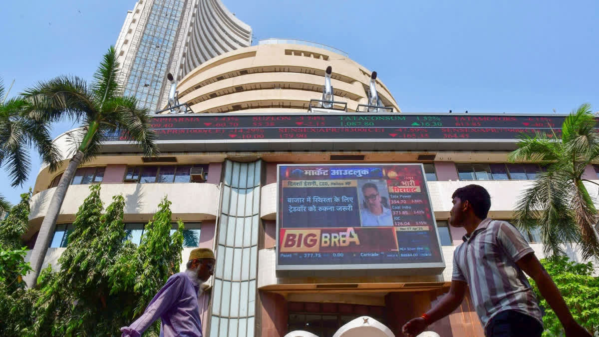 People walk past the Bombay Stock Exchange (BSE) building, in Mumbai, Monday, April 7, 2025.