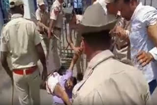 Police takes away a farmer during a demonstration at the Collectorate