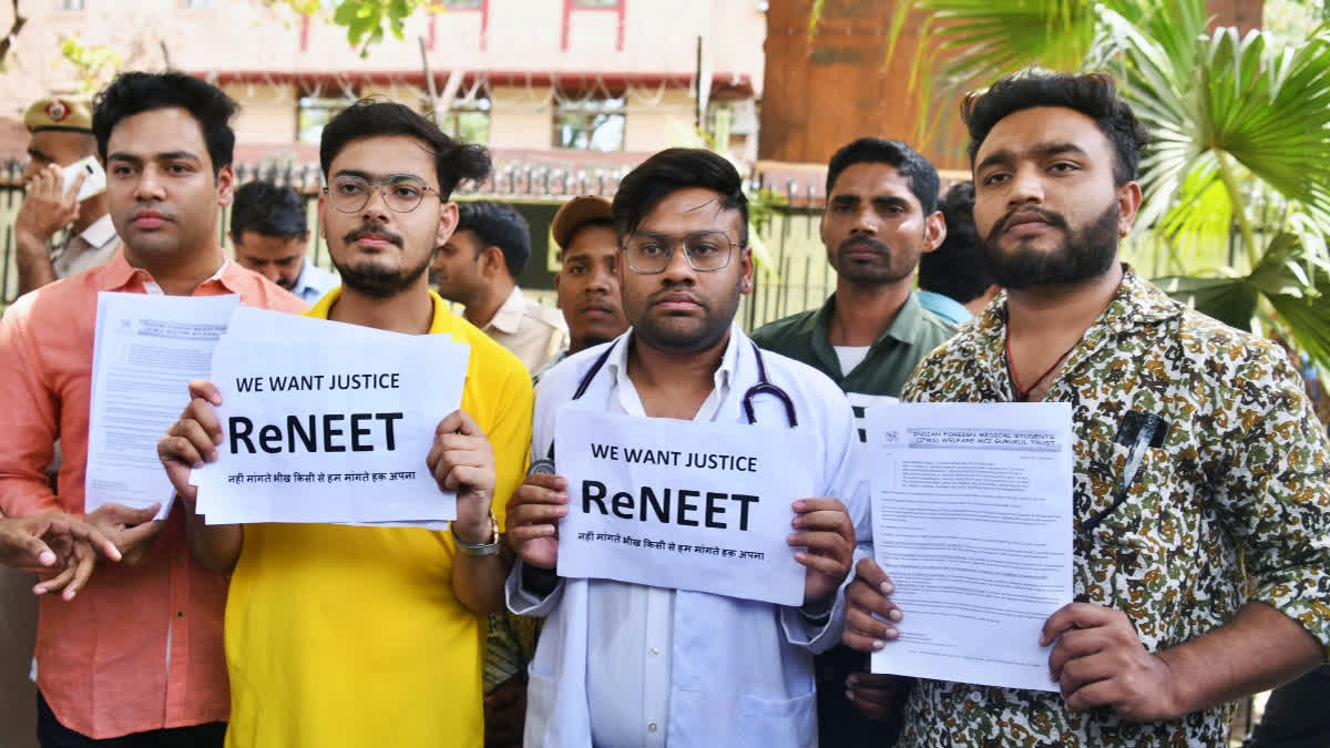 Students holding placards protest against the alleged irregularities in the NEET examination, at Shashtri Bhawan in New Delhi on June 14, 2024.