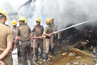 Firefighters douse the blaze at the Khidderpore market in Kolkata on Monday.