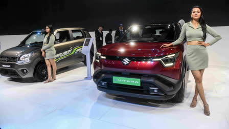 FILE - Models stand next to the cars at Bharat Mobility Global Expo 2025, in New Delhi