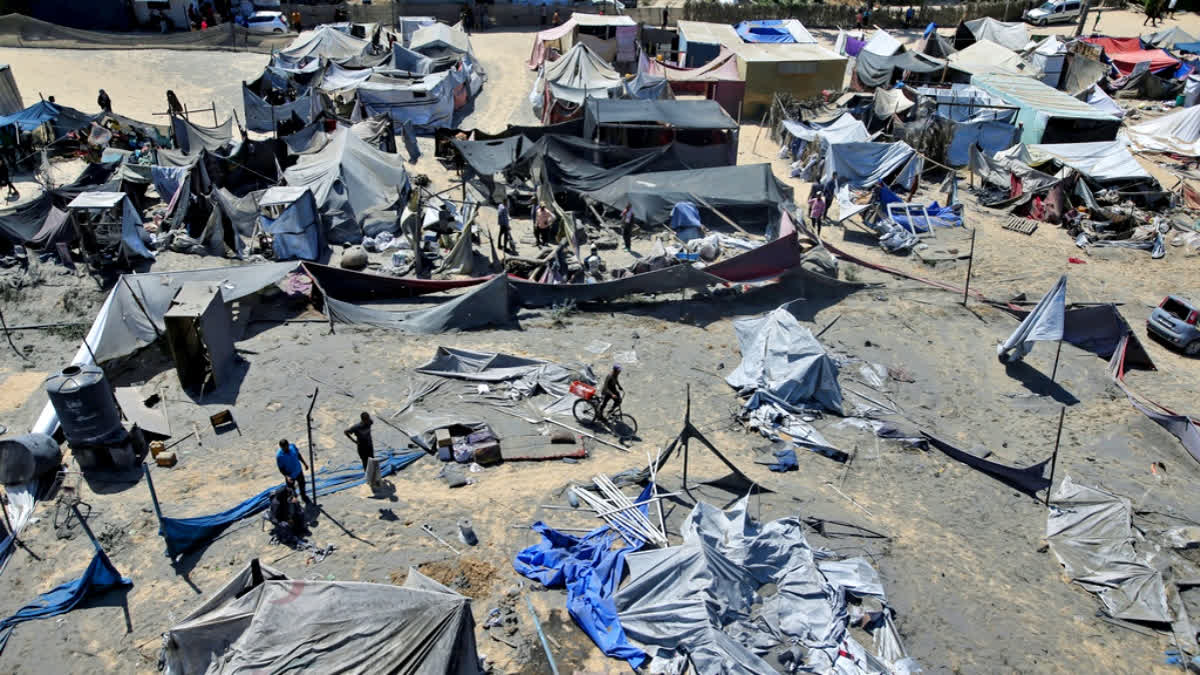 Palestinians inspect the damage at a site hit by an Israeli bombardment on Khan Younis, southern Gaza Strip, Saturday, July 13, 2024