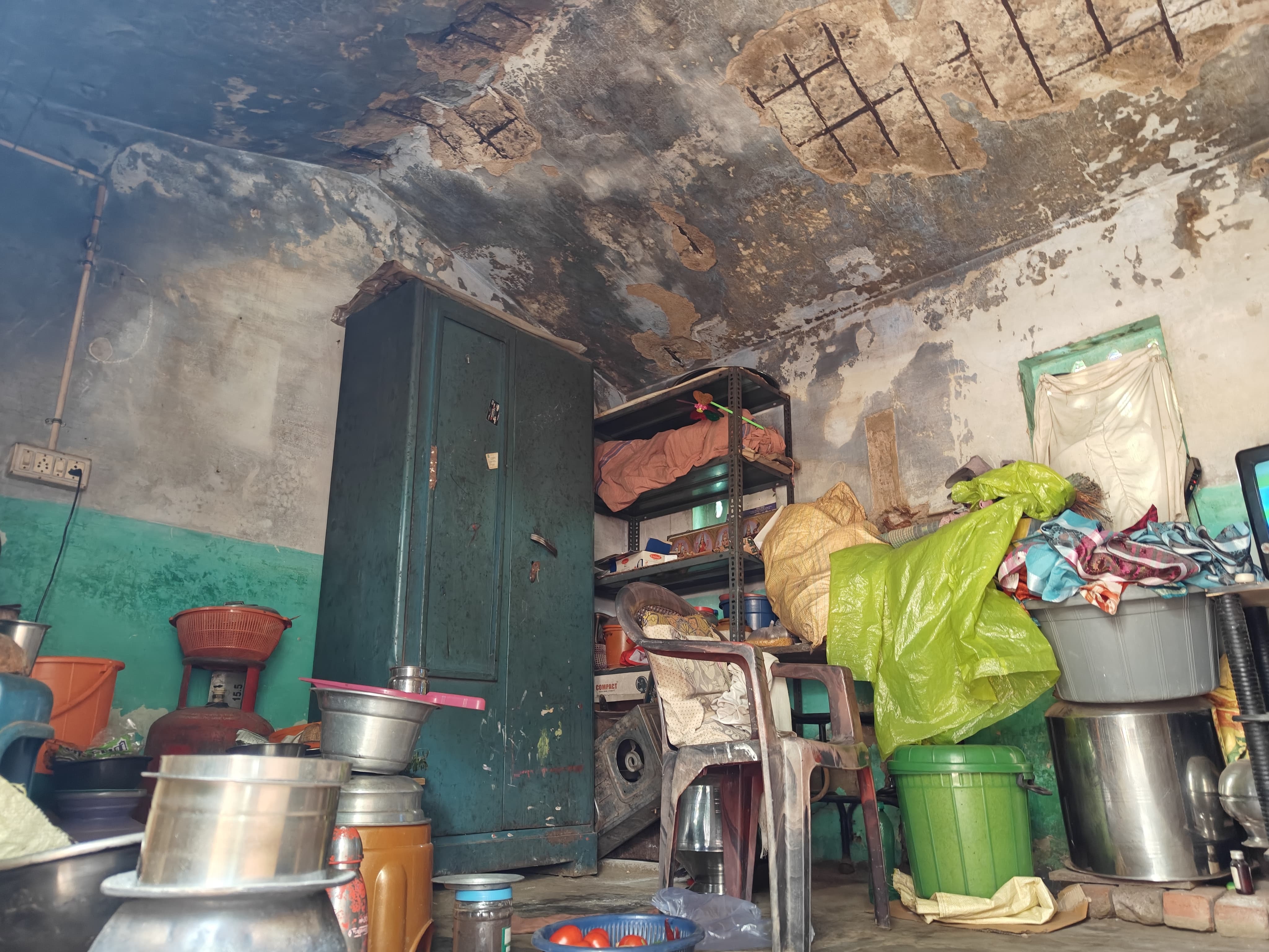 மேற்கூரையின் பூச்சு பெயர்ந்து விழுந்த வீடு